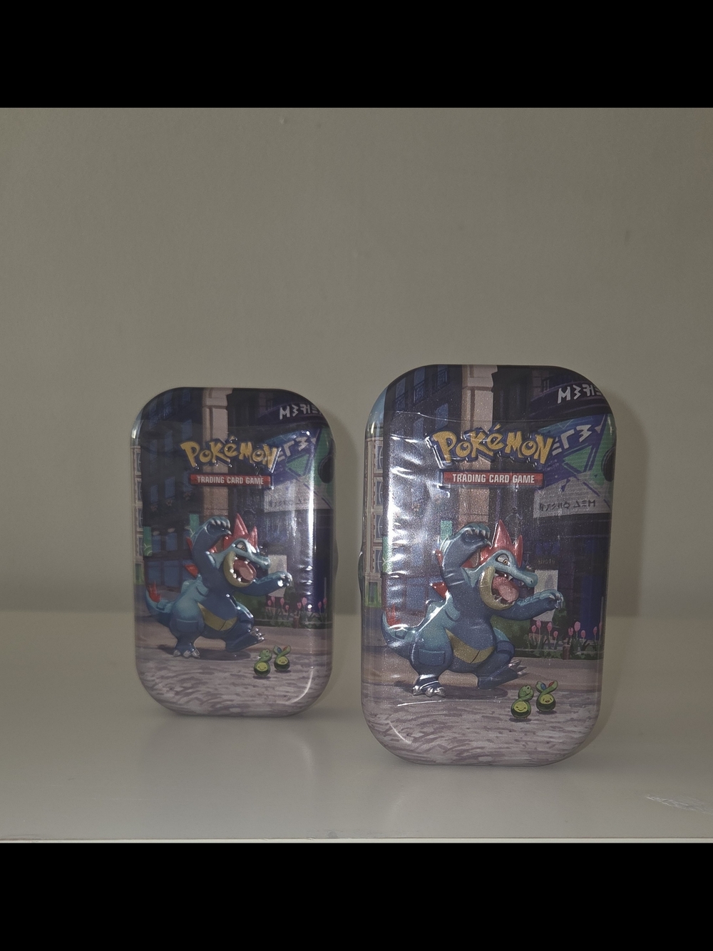 2 Lumiose City Mini Tin featuring Feraligatr and Budew.